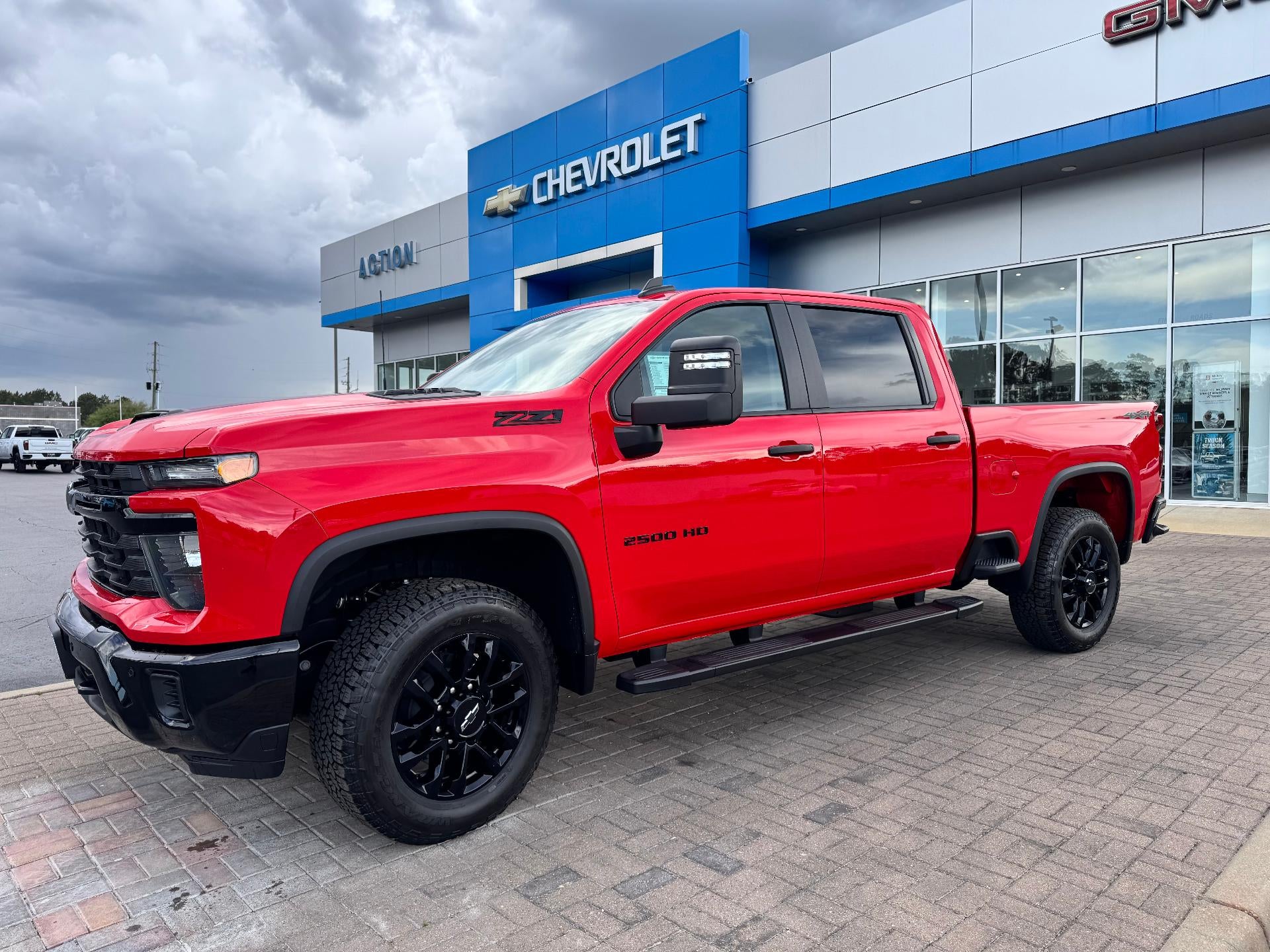 2026 Chevrolet Silverado 2500 HD Custom in Red Hot — front three-quarter view